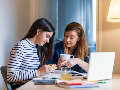 Tutor working with student at their desk